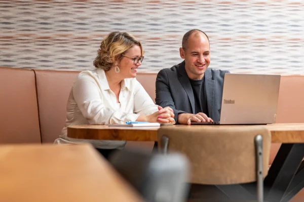 Collega's vergaderen via laptop